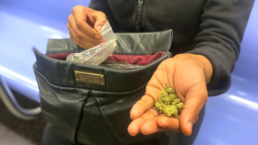 Woman holds weed on NYC subway train. (Meg Schmidt)
