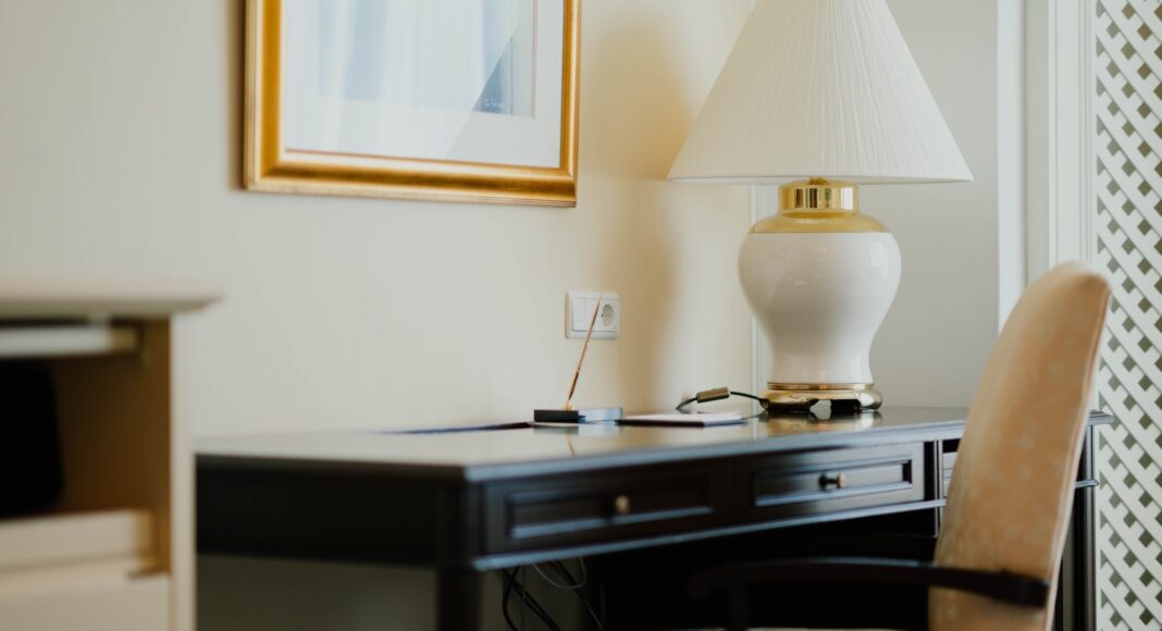 white and gold table lamp on black desk