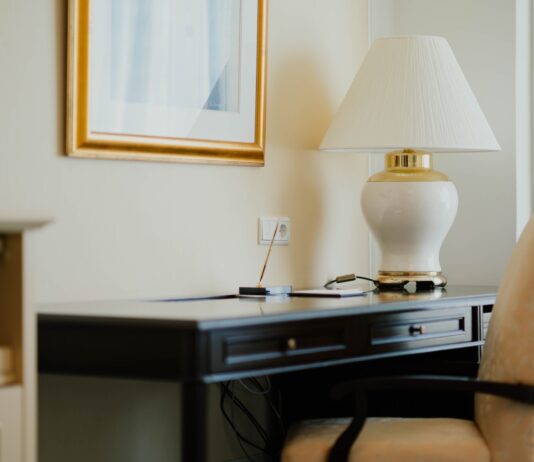 white and gold table lamp on black desk